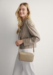 Small beige women's handbag TOREC-1173-1B(W26), front view of the product on the model's shoulder. Half of the silhouette visible.