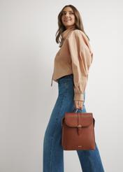Women's cognac backpack TOREC-1198-1F(W26), product view in model's hand. Full body visible.