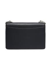 Small black women's handbag with an elegant clasp TOREC-1322-99(Z26), product view from the back on a light background.