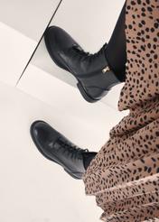 Black women's leather ankle boots BUTYD-1115-99(Z25), view of the product on the model's feet against a light background.