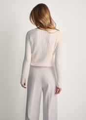 Cream women's cardigan with buttons KARDT-0044A-12(Z25), product visible from the back on the model, half of the silhouette visible.