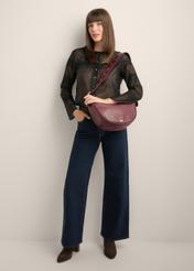 Burgundy semi-circular women's handbag TORES-1350-4D(Z26), front view of the product on the model's shoulder, on a light background.