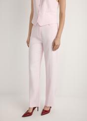 Light pink elegant women's trousers SPODT-0106A-5A(W26), product view from the front on the model, half of the silhouette visible.