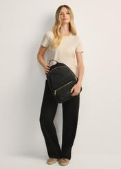 Black quilted women's backpack TOREN-0265A-99(Z25), product view from the front on the model, the whole silhouette is visible.