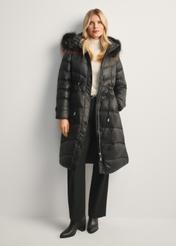 Black women's winter jacket with natural fur KURDT-0618-99(Z25), front view of the product on the model, the entire silhouette is visible.
