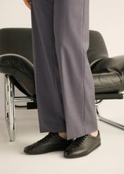 Women's black leather sneakers BUTYD-1293-9I(Z26), side view of the product on the model's feet.