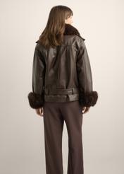 Women's dark brown leather jacket KURDS-0616-1I(Z26) - back view of the product, on a model, against a light background. Half of the silhouette visible.