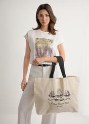Cream cotton tote bag with print TOREN-0136-0P(W26), product view on model's shoulder. Half of silhouette visible.