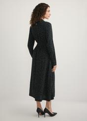 Black polka dot dress SUKDT-0258-9P(W26), back view of the product on the model. Full body visible.