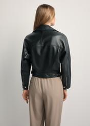 Women's short black leather jacket KURDS-0607-99(W26) - back view of the product, on a model, against a light background. Half of the silhouette visible.