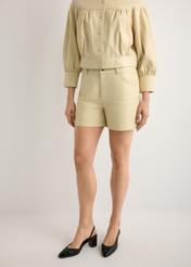 Women's leather light yellow shorts SPODS-0035-2A(W26), product view from the front on the model, half of the silhouette visible.