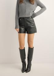 Women's black leather shorts SPODS-0007-99(KS), front view of the product on the model. Half of the silhouette visible.