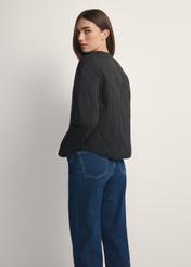 Black women's transitional nylon jacket KURDT-0656-99(W26), product view from the back on the model, half of the silhouette visible.