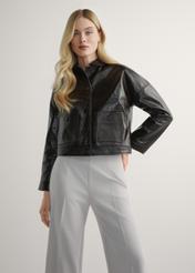 Women's brown short leather jacket KURDS-0593-1I(W26) - front view of the product, on a model, against a light background. Knee-length silhouette visible.