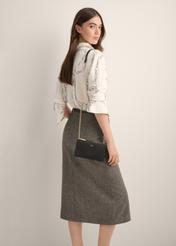 Black TOREC-1349-99(Z26) phone case bag, product view on model's shoulder. Half of silhouette visible.