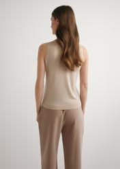 Beige wool and silk blouse BLUDT-0209-1B(W26) - back view of the product, on a model, against a light background. Knee-length silhouette visible.