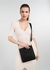 Black women's shoulder bag TOREC-0708B-99(Z25) - front view of the product on a model on a white background. Half of the silhouette visible.