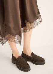 Women's dark brown suede moccasins BUTYD-1187-1I(Z26), diagonal view of the product on the model. Half of the silhouette visible.