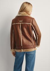 Brown short women's sheepskin coat KOZDP-0001A-89(Z25), product view from the back on the model, half of the silhouette visible.