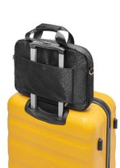 Black women's bag with monogram TOREN-0299-99(W25), product view on suitcase on white background.