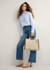 Beige women's tote bag TOREN-0288A-1E(W26), product view in model's hand. Full body visible.