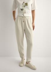 Light beige women's trousers SPODT-0108-1A(W26), front view of the product on the model. Half of the silhouette visible.