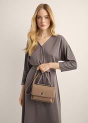 A small women's handbag with an elegant clasp in a cool beige shade, model TOREC-1322-1K(Z26). View with a model.