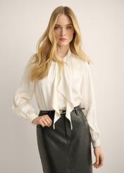 A creamy, elegant women's blouse with a tie, model BLUDT-0213-0C(Z26). Front view of the product on a model. Half of the figure is visible.