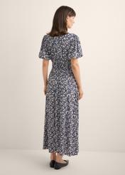 Long floral dress in navy blue SUKDT-0191-7I(W26), back view of the product on the model. Full body visible.