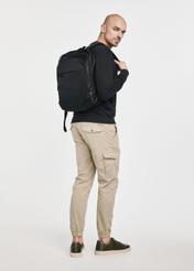Men's black backpack with laptop compartment TORMN-0264C-99(Z25), product view on model. Full body visible.