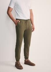 Men's khaki sweatpants SPOMT-0101-55(Z25), front view of the product on the model. Half of the silhouette visible.