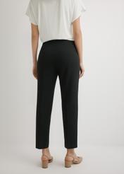 Black elegant women's trousers SPODT-0109-99(W26), back view of the product on the model. Half of the silhouette visible.