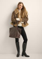Brown leather women's shopper bag TORES-1380-1H(Z26), diagonal view of the product on the model. Full body visible.