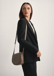 Dark beige leather semi-circular messenger bag TORES-0972F-1K(W26), diagonal view of the product on the model, half of the silhouette visible.