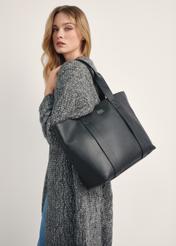 Black elegant women's shopper bag TORES-1200-99(Z25), view of the product on the model's shoulder against a light background.