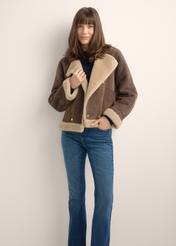 Women's dark brown short sheepskin coat KOZDP-0018-1I(Z26), front view of the product on a model. Half of the silhouette visible.
