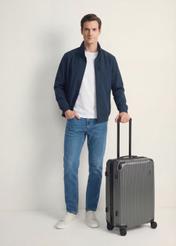 Medium suitcase on wheels WALAB-0073-9C-24(W26), diagonal view of the product next to the model's silhouette.