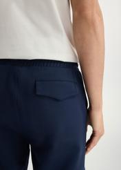 Navy blue men's sweatpants SPOMT-0109-69(W25) - close-up of detail from the back on the model on a white background.