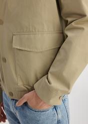 Beige men's transitional jacket KURMT-0365-82(W25) - close-up of detail on model on white background.