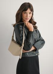 Beige small handbag made of natural leather TORES-1267-1B(W26), front view of the product on a model, half of the silhouette visible.