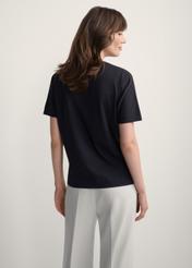 Women's black T-shirt with print TSHDT-0146-99(Z25), back view of the product on the model. Half of the silhouette visible.