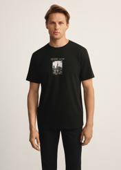 Black men's T-shirt with print TSHMT-0132-99(Z25), front view of the product on the model, half of the silhouette visible.