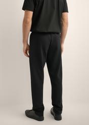 Men's black sweatpants SPOMT-0127-99(Z26), product view from the back on the model. Half of the silhouette visible.