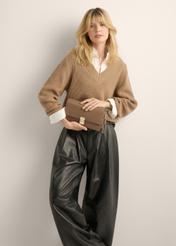 Light brown leather shoulder bag TORES-1418-1K(Z26) - front view of the bag, held by the model, against a light background. Knee-length silhouette visible.