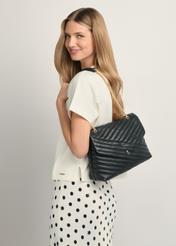 Black leather women's handbag with quilting TORES-1286-99(W26), front view of the product on a model, half of the silhouette visible.