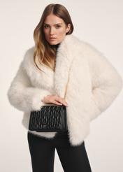 Black women's handbag with chain TOREC-1102-99(Z25), product view on a model. Half of the silhouette visible.