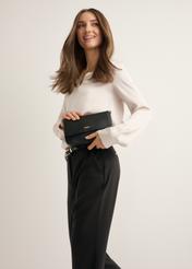 Black women's shoulder bag TOREC-1255-99(Z26), front view of the product on a model. Half of the silhouette visible.