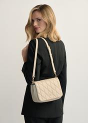 Cream women's handbag with stitching TOREC-1151-0B(W26), product view on model's shoulder. Half of silhouette visible.