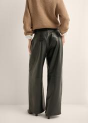 Women's wide-leg black leather trousers SPODS-0050-99(Z26), product view from the back on the model. Half of the silhouette visible.