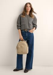 Beige women's backpack TOREC-1253-1B(Z26), product view in model's hand. Full body visible.